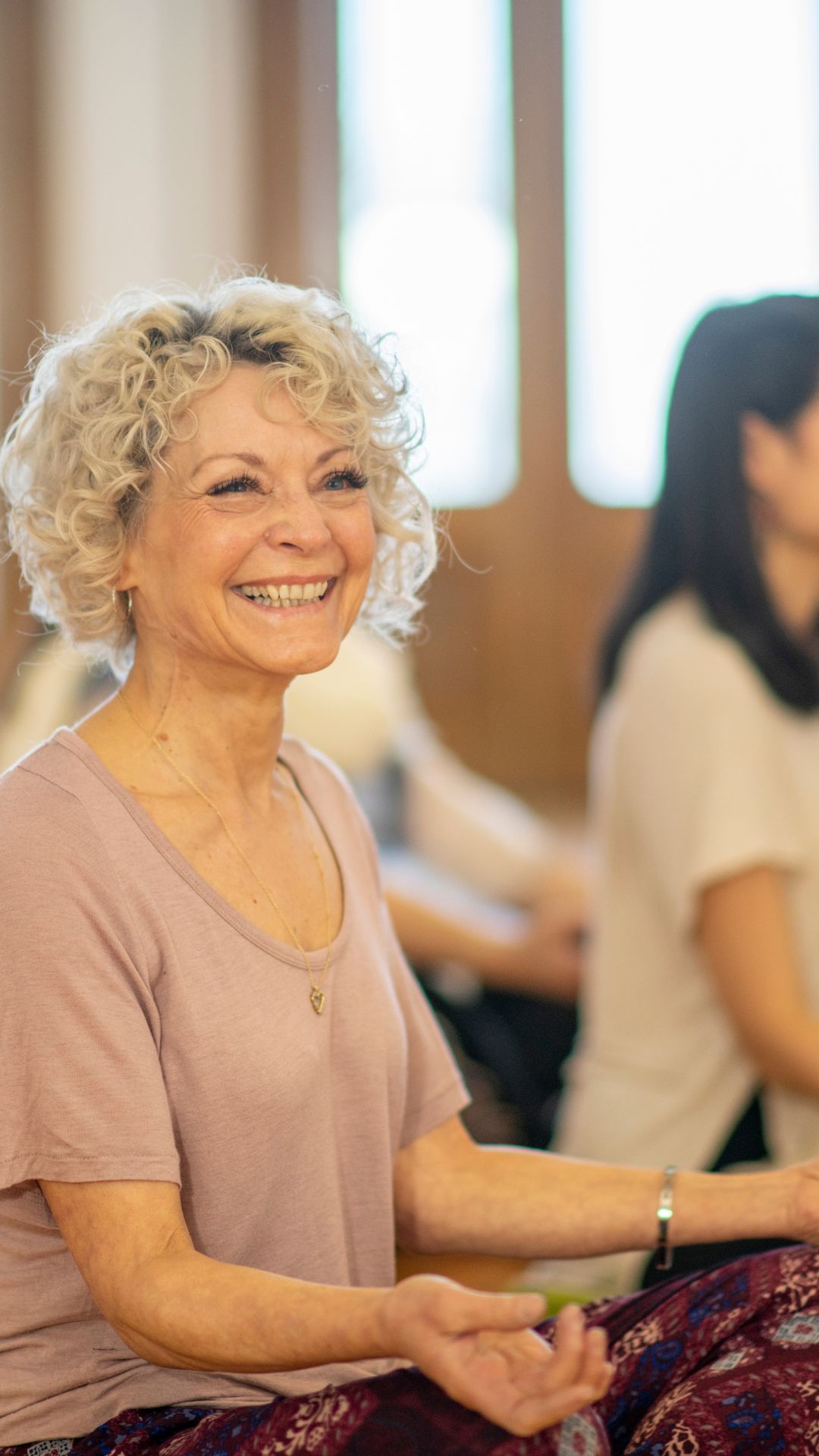 Older women doing yoga and smiling